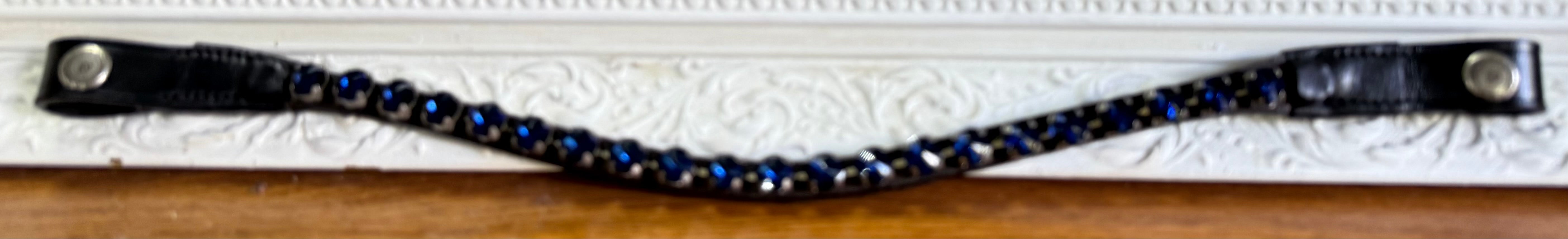Black leather browband with a single row of blue Stellux crystals, designed for dressage and show riders.